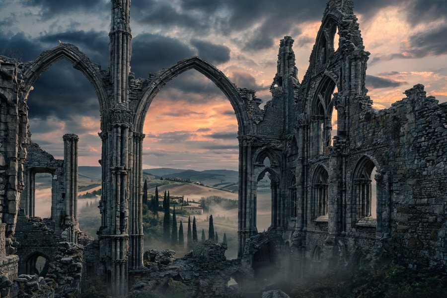 Archi ogivali gotici dell'abbazia di San Galgano che inquadrano il cielo tempestoso, paesaggio toscano visibile tra le finestre di pietra, stile Friedrich